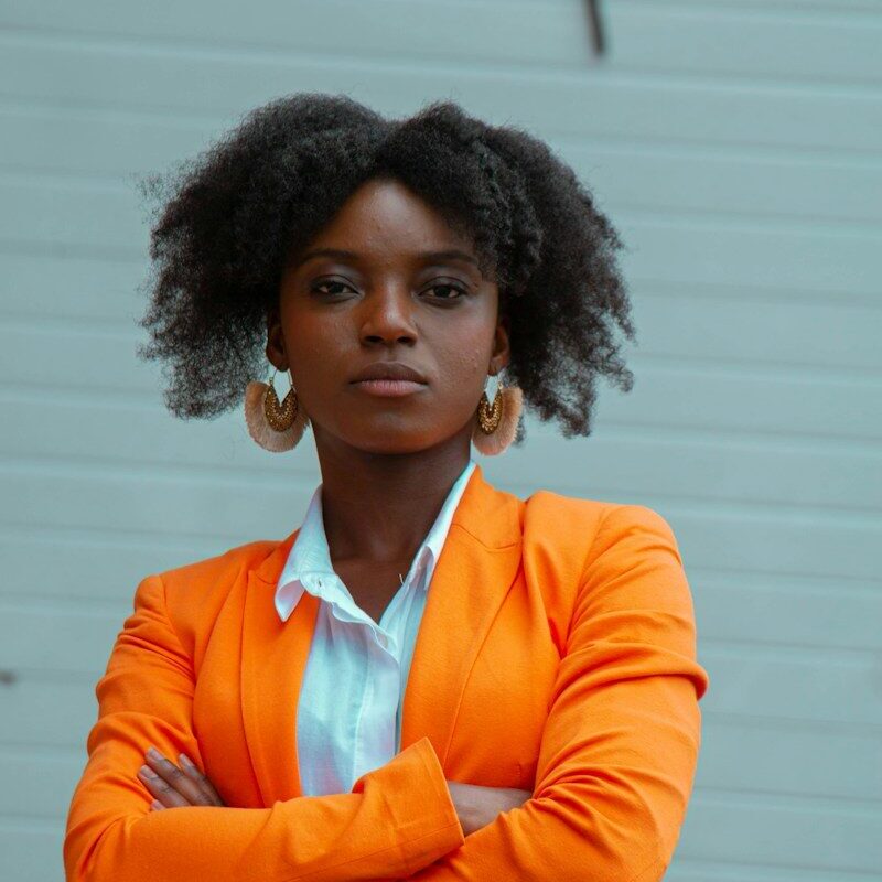 Trademark renewal in Kenya: African businesswoman in an orange blazer representing a trademark owner