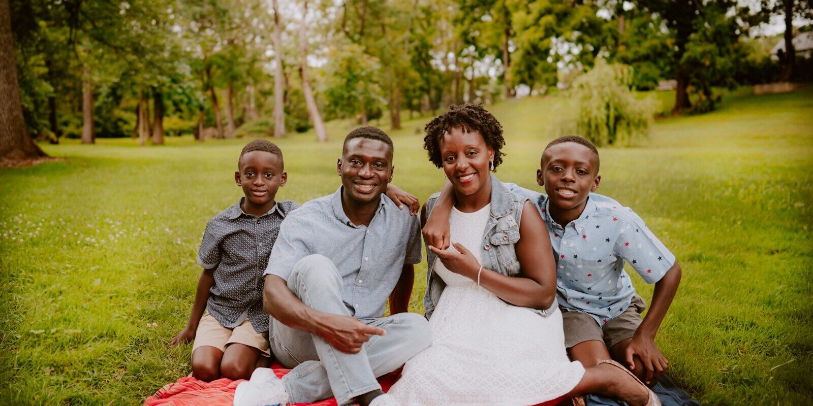 Kenyan family sitting together outdoors, illustrating the choice between a trust, a will or a company for family wealth