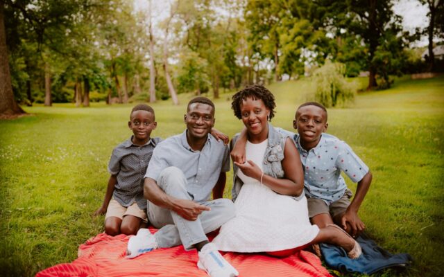 Kenyan family sitting together outdoors, illustrating the choice between a trust, a will or a company for family wealth