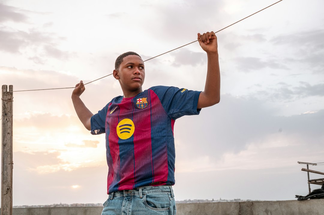 African athlete in football jersey representing sports sponsorship and advertising rules in Kenya