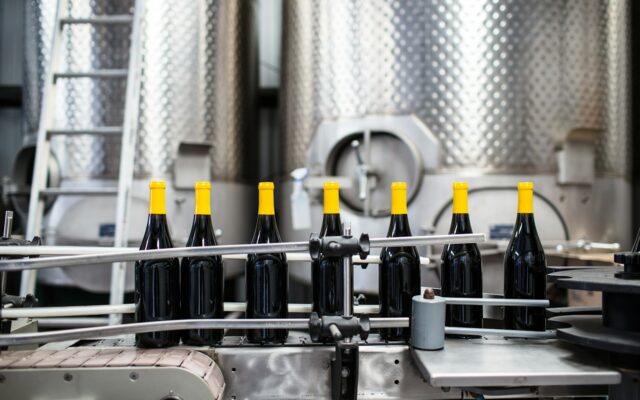 Bottles moving through a beverage manufacturing production line