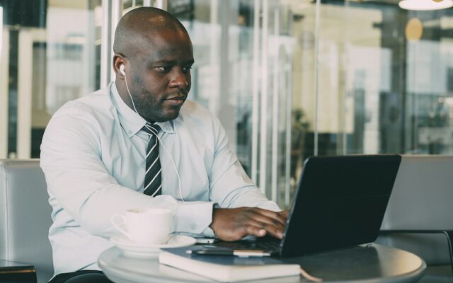 A focused businessman working on his laptop at a table
