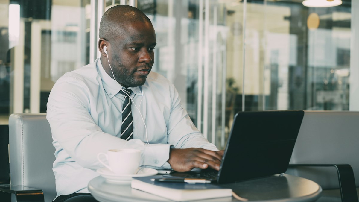 A focused businessman working on his laptop at a table