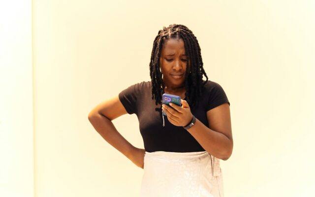 A concerned businesswoman looking at her phone