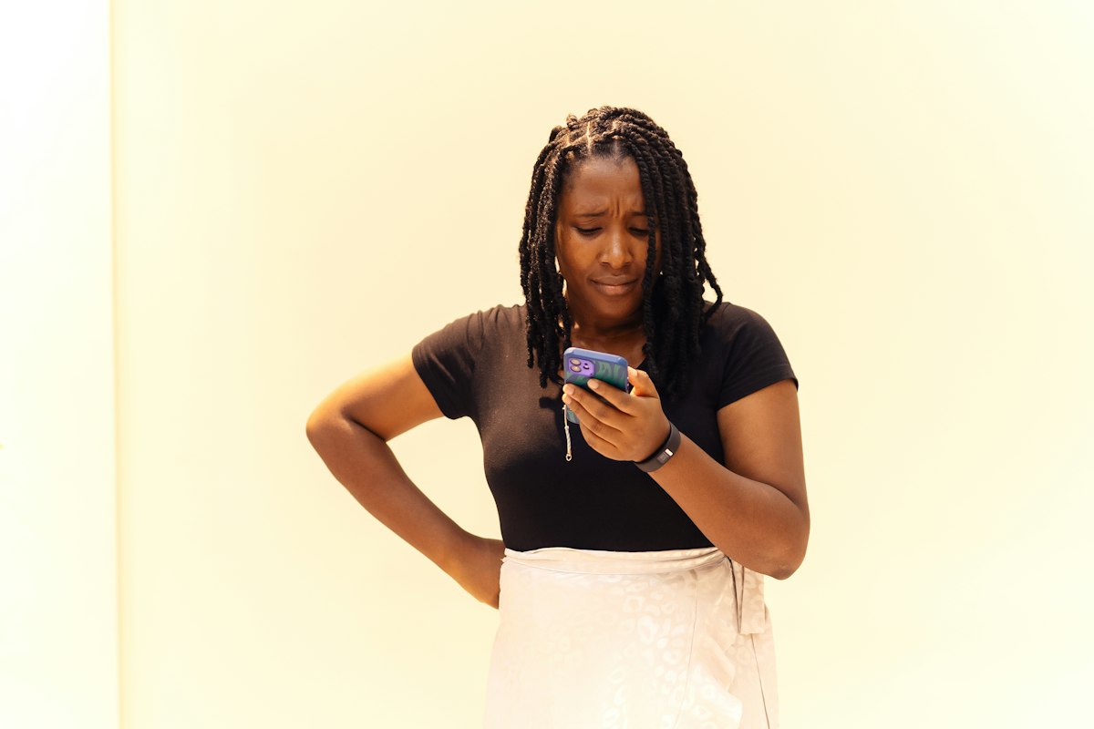 A concerned businesswoman looking at her phone