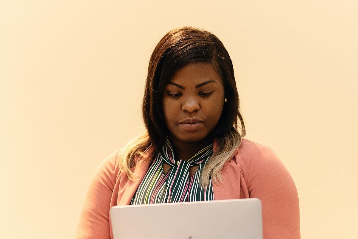 A serious businesswoman looking at her laptop