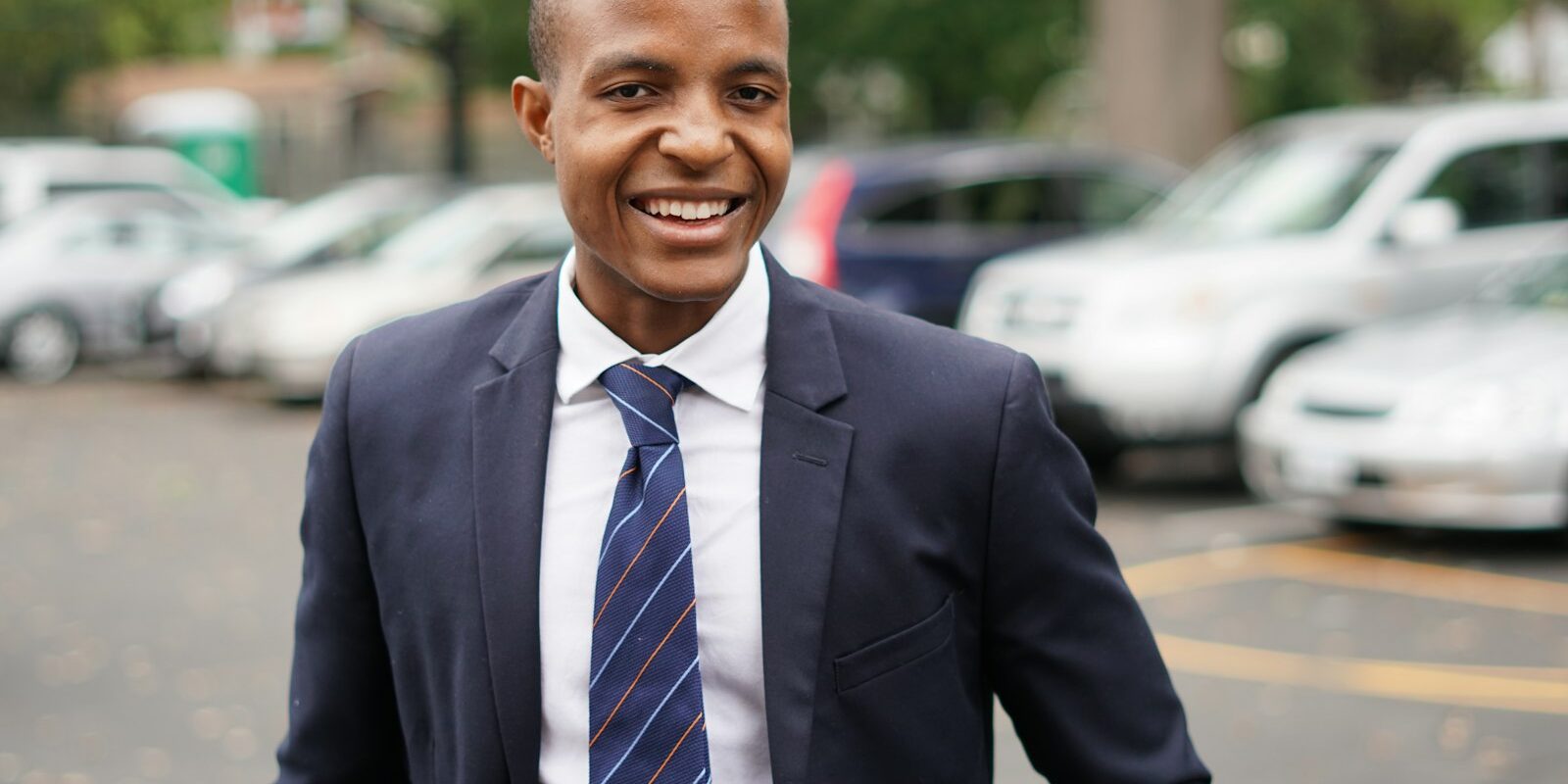 Smiling African businessman in a suit, representing a foreign investor applying for a Kenyan work permit
