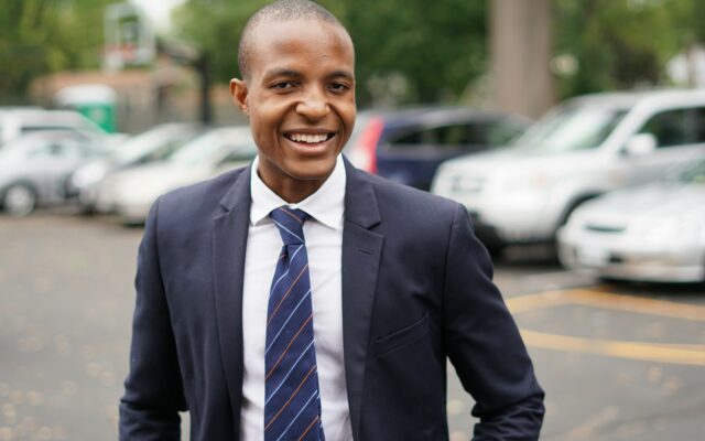 Smiling African businessman in a suit, representing a foreign investor applying for a Kenyan work permit