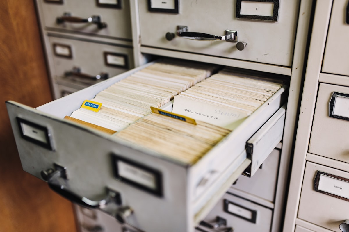 An open filing cabinet drawer holding company records