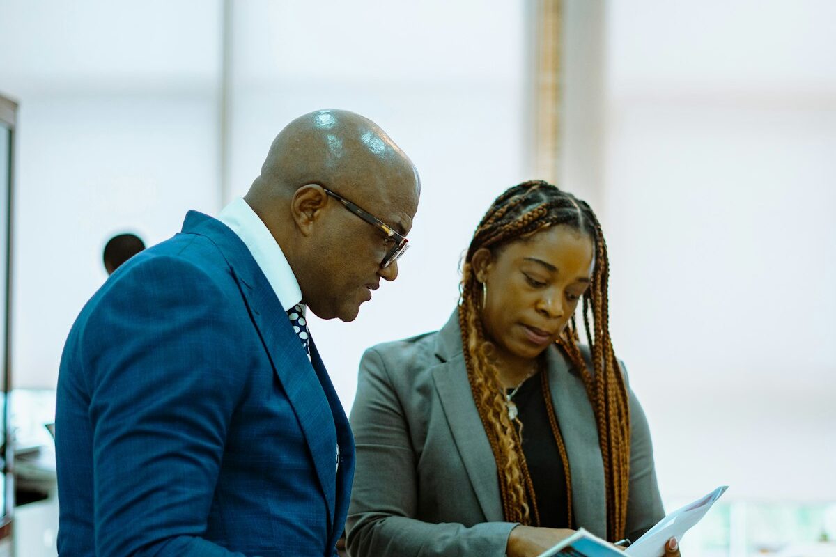 Two professionals reviewing a document together in an office