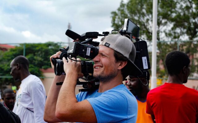 Cameraman filming a live sports broadcast representing copyright protection in Kenya