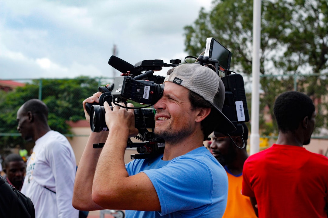 Cameraman filming a live sports broadcast representing copyright protection in Kenya