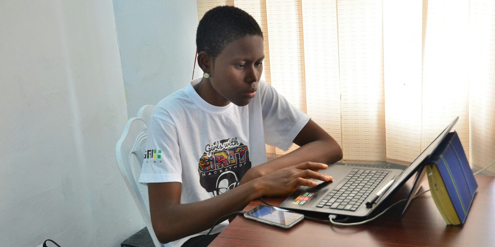 Person working at a desk with a laptop, setting up a new business