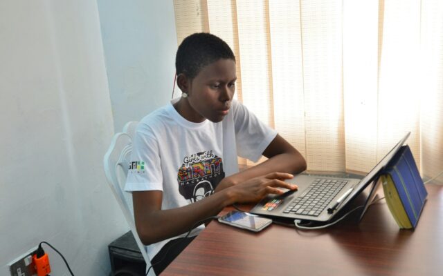 Person working at a desk with a laptop, setting up a new business