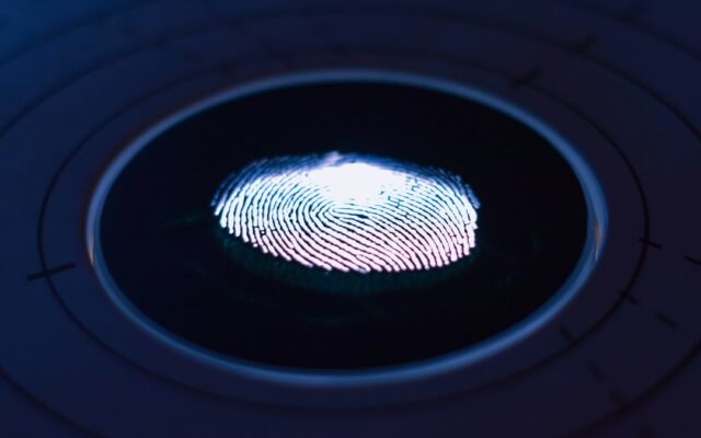 Glowing fingerprint scan representing biometric data protection for sports bodies in Kenya