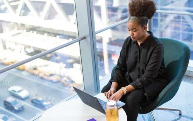 Enterprise professional reviewing a colocation services agreement on a laptop in a high-rise office, representing data centre contract negotiation in Kenya