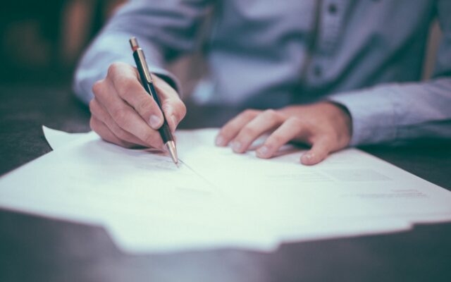 A director writing and signing a company document