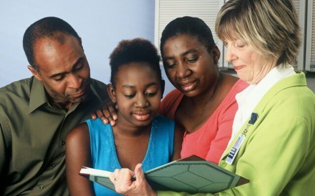 Family reviewing a care plan with an adviser, illustrating a trust set up for a disabled or vulnerable family member in Kenya