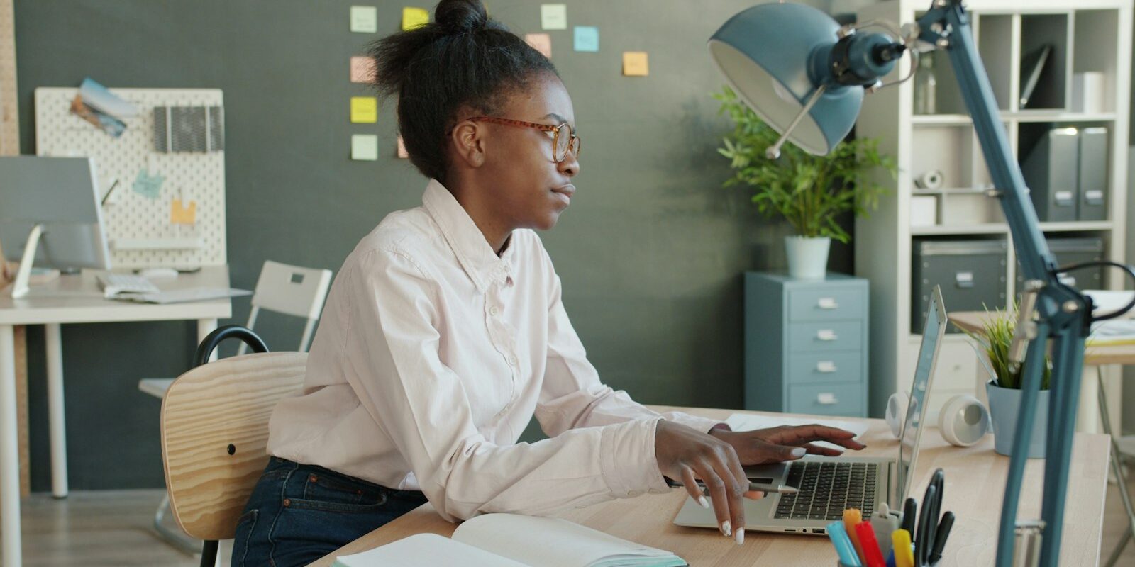 African professional working on a laptop at a desk for a foreign company through an employer of record in Kenya