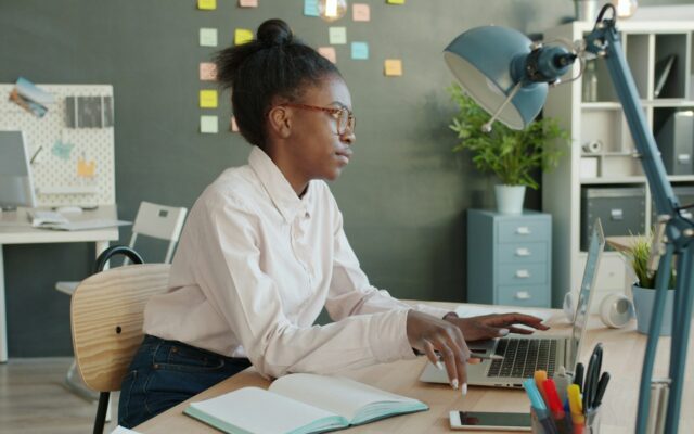 African professional working on a laptop at a desk for a foreign company through an employer of record in Kenya