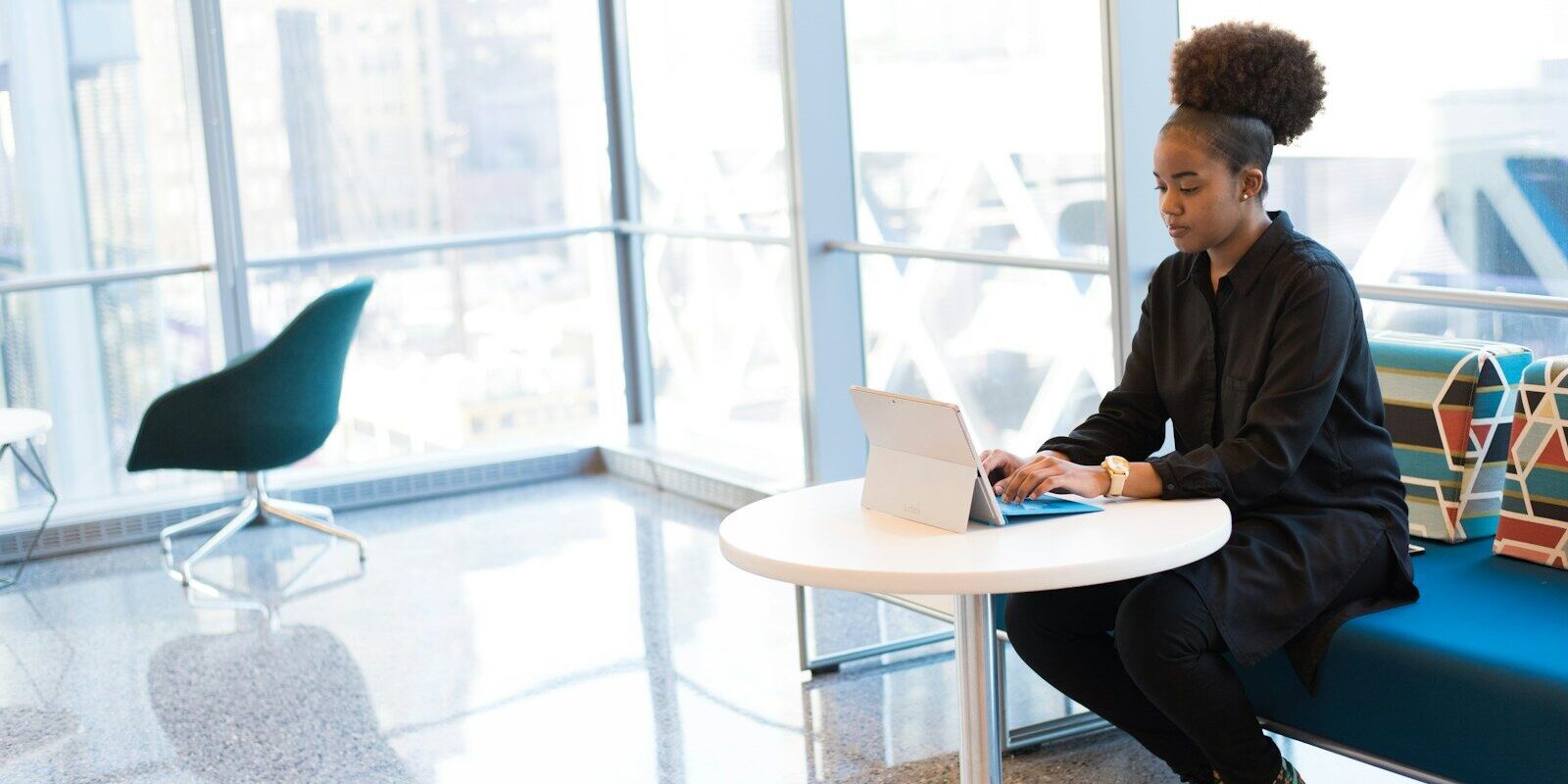 African professional reviewing tax documents on a tablet in a modern office, representing income tax deduction compliance under Kenya's eTIMS rules