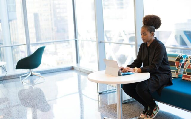 African professional reviewing tax documents on a tablet in a modern office, representing income tax deduction compliance under Kenya's eTIMS rules