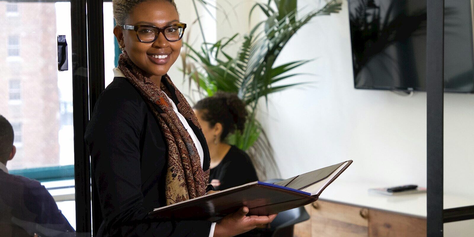 African businesswoman in an office, representing a life sciences investor planning an exit in Kenya
