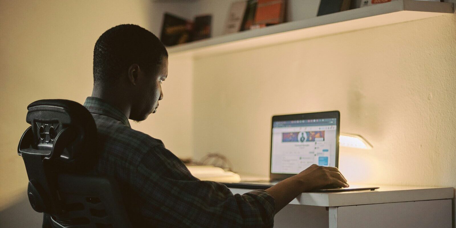 Kenyan lender reviewing a security right registration on a laptop at the E-Collateral Registry
