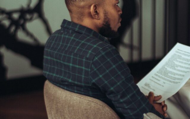 Restoring a removed trademark: man reading a trademark register document in a modern office