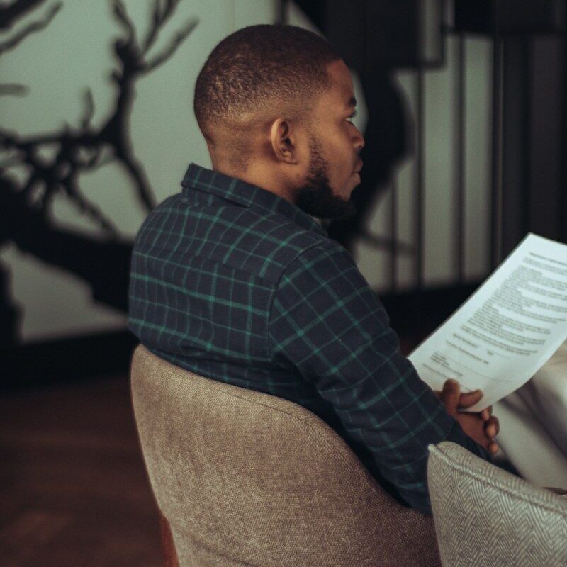 Restoring a removed trademark: man reading a trademark register document in a modern office