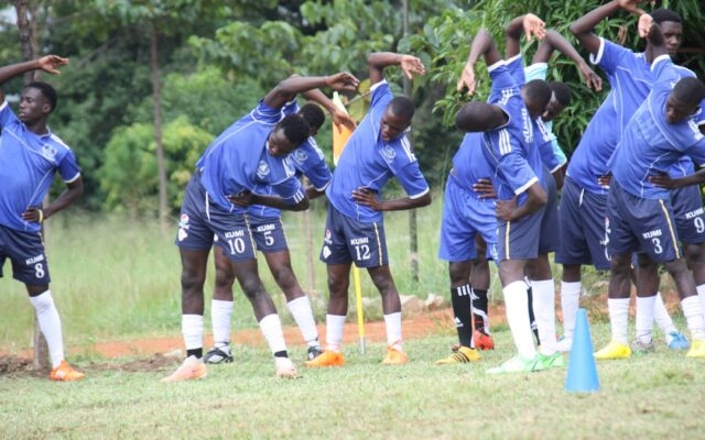 Football club players training on a pitch representing FKF club licensing in Kenya