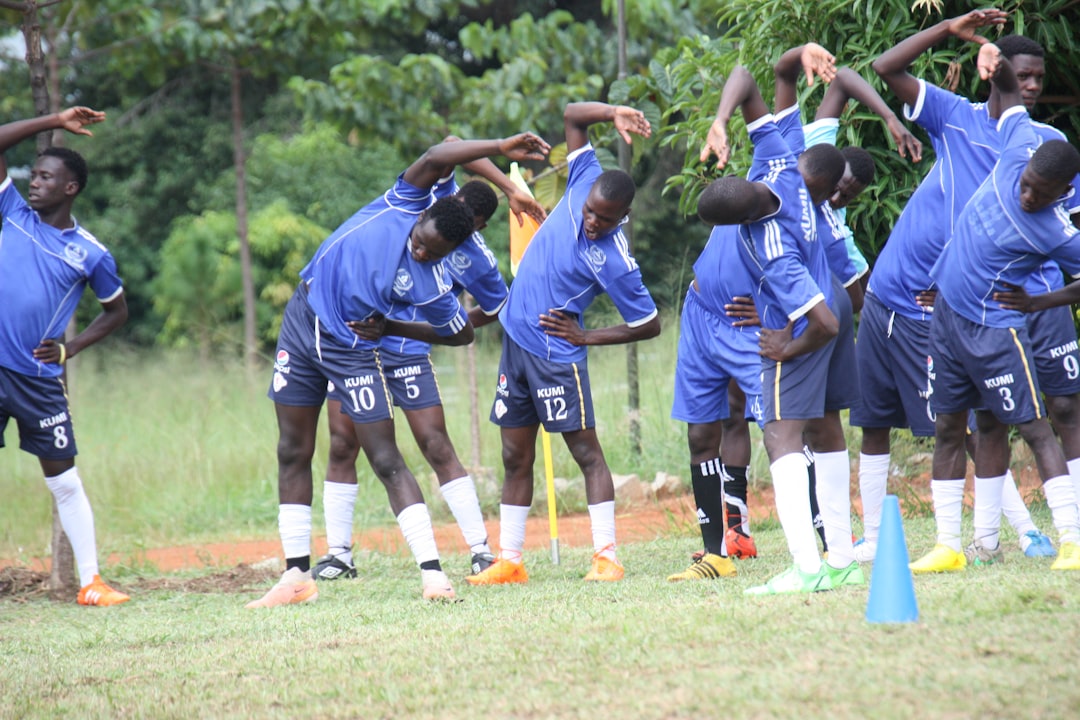 Football club players training on a pitch representing FKF club licensing in Kenya