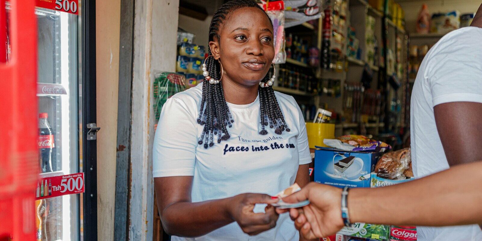 African retail shop owner at a small storefront in Kenya