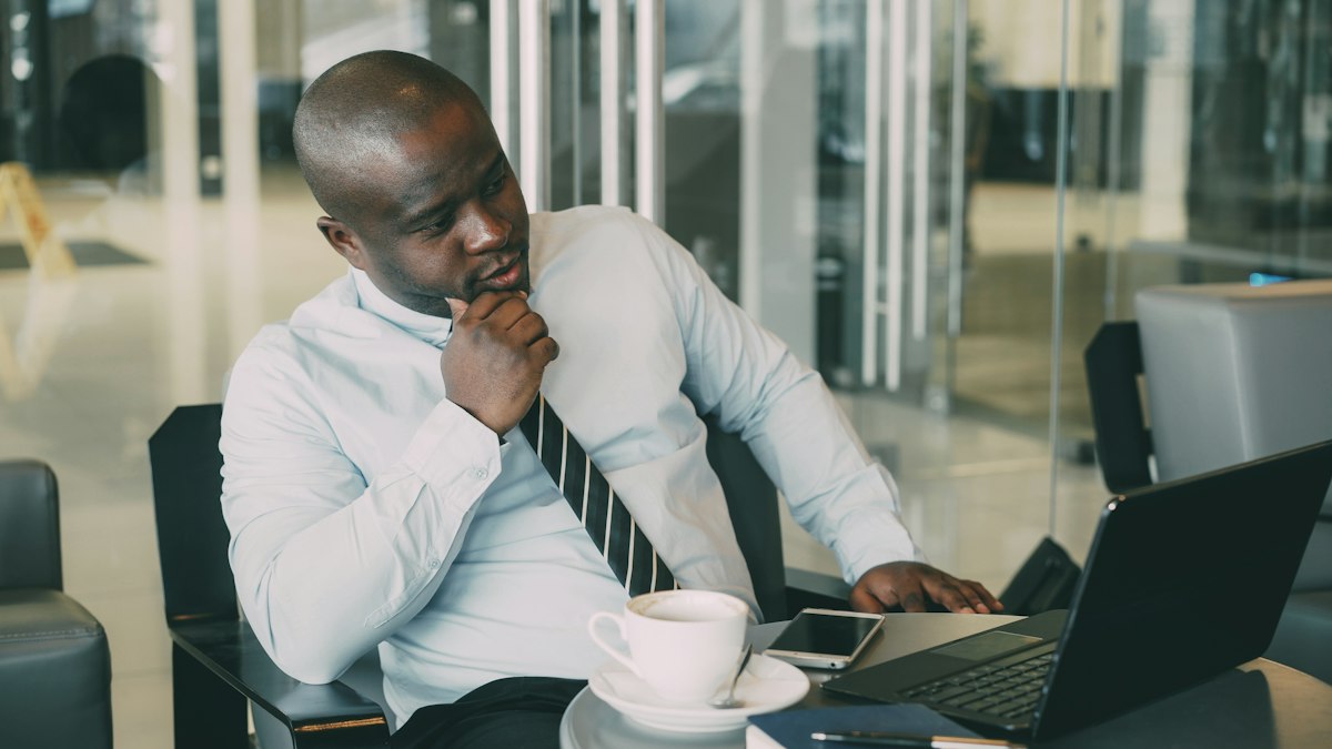 A businessman thinking while working at his laptop