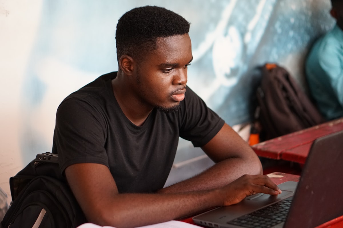 A man focused on his laptop screen responding to an urgent matter