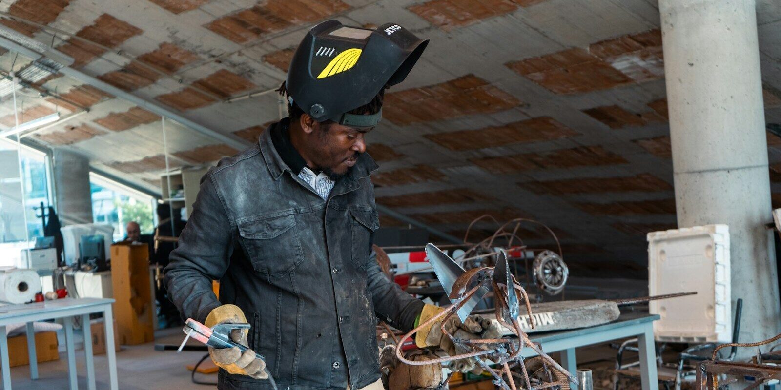 African industrial technician working with metal equipment, representing manufacturers and facilities affected by Kenya's new mandatory calibration rules