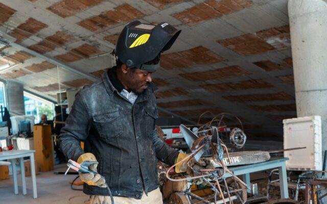 African industrial technician working with metal equipment, representing manufacturers and facilities affected by Kenya's new mandatory calibration rules