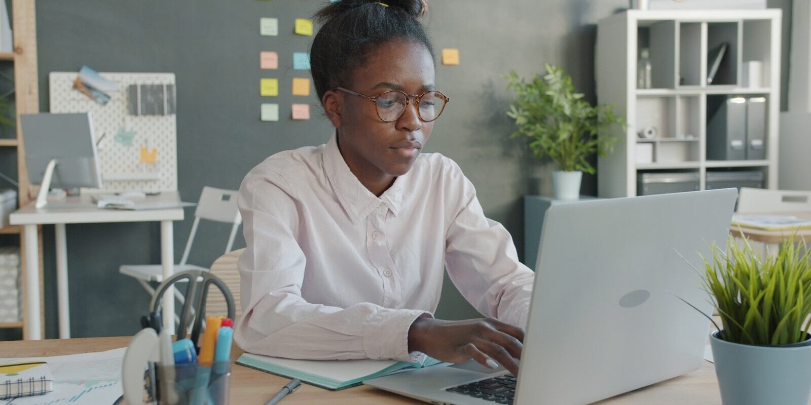 In-house counsel working on a laptop, representing remote management of Kenyan litigation from outside the country