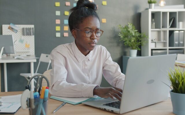 In-house counsel working on a laptop, representing remote management of Kenyan litigation from outside the country