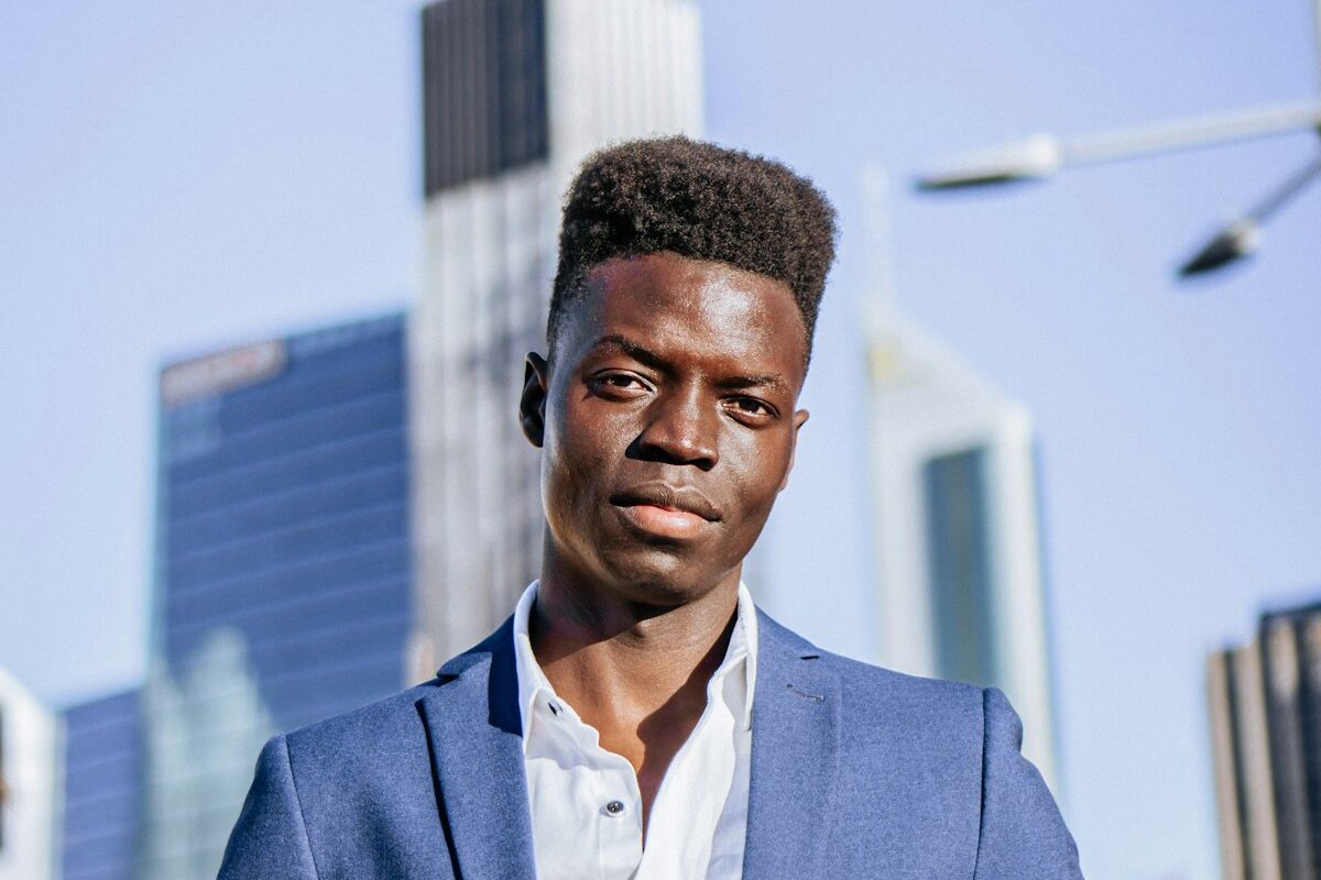 African businessman in a suit with a city financial district skyline behind him, representing private credit funds and alternative lending in Kenya