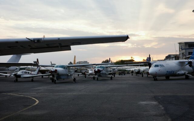 Small aircraft parked on an airport tarmac at sunset, representing Kenya's Air Passenger Service Charge Act
