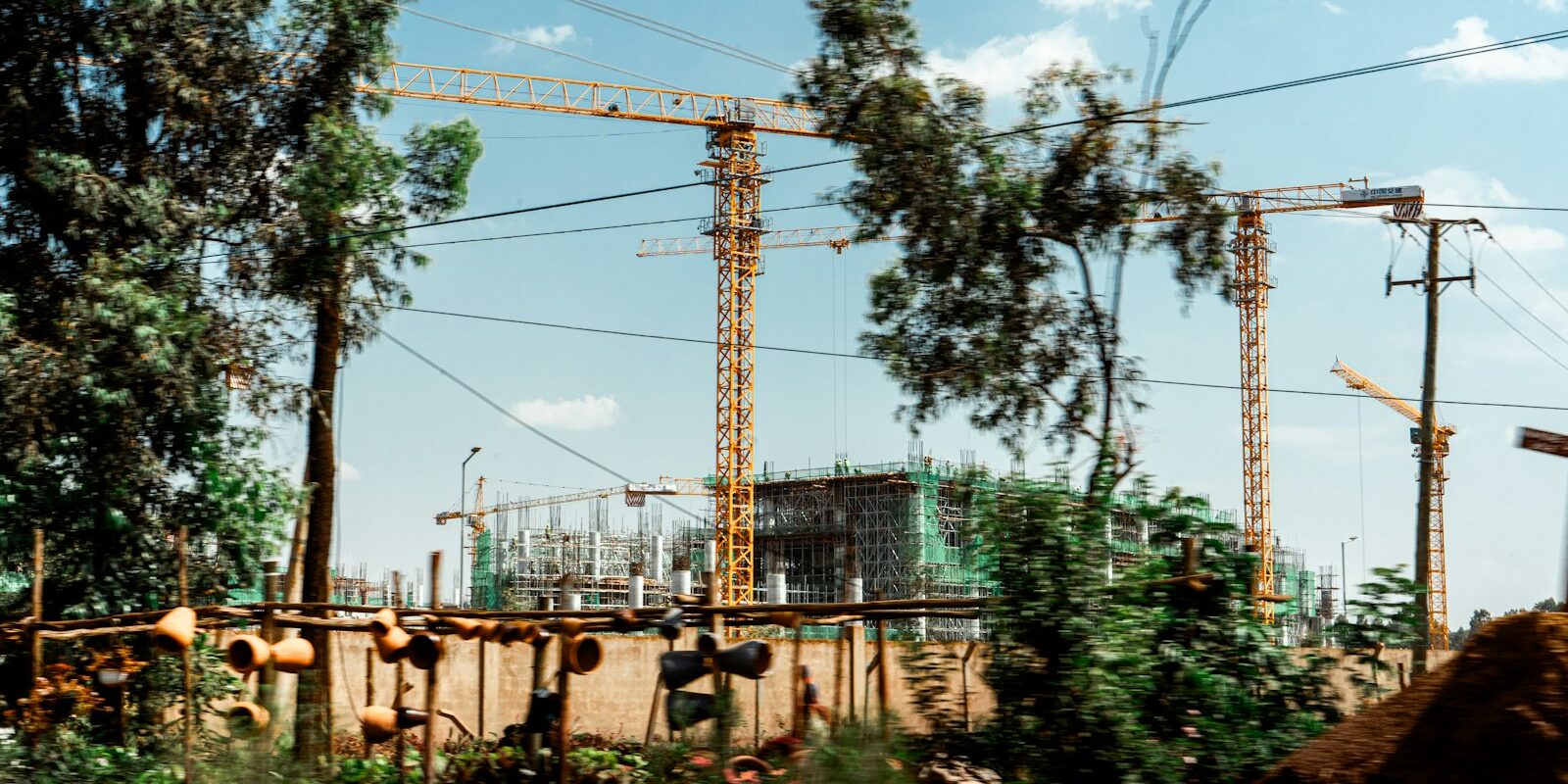 Real estate tokenisation in Kenya: tower cranes over a building site in a Kenyan city