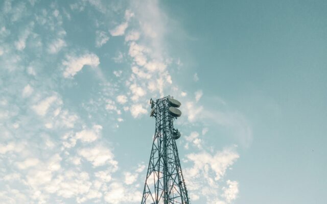 Telecommunications tower against a cloudy sky