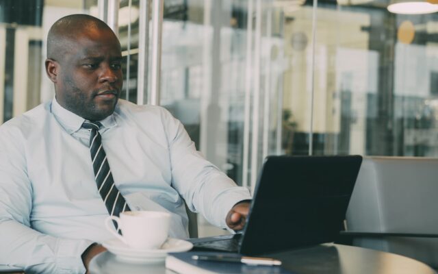 African business professional working on a laptop in a modern office, representing a foreign investor evaluating Special Economic Zone eligibility in Kenya