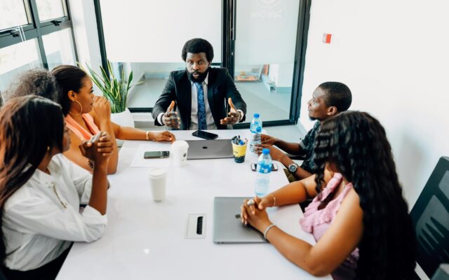 African professionals in a meeting discussing Kenya's work permit classes