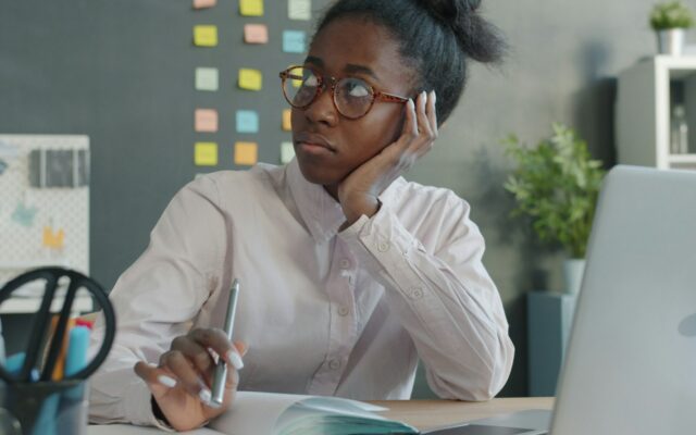 African businesswoman reviewing a rejected work permit application at her desk