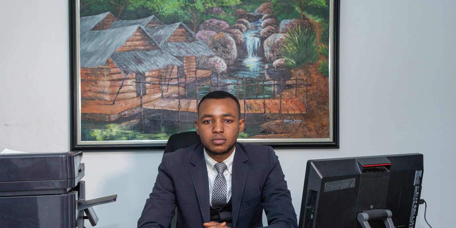 Kenyan financial services professional working at a desk in an office, representing digital asset tax compliance advisory