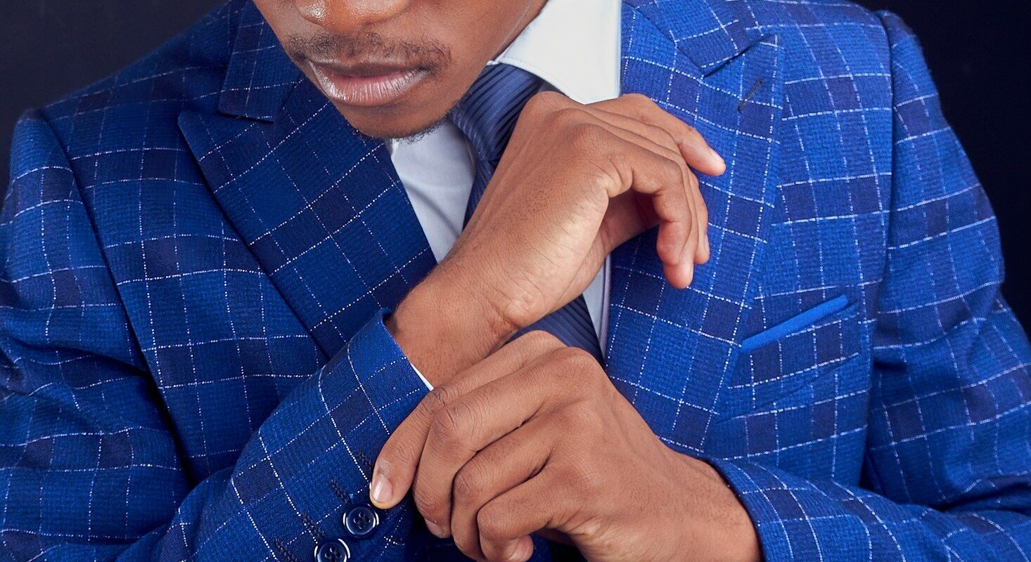 IP assignment tax in Kenya: African professional in a blue check suit, representing a buyer or seller of intellectual property