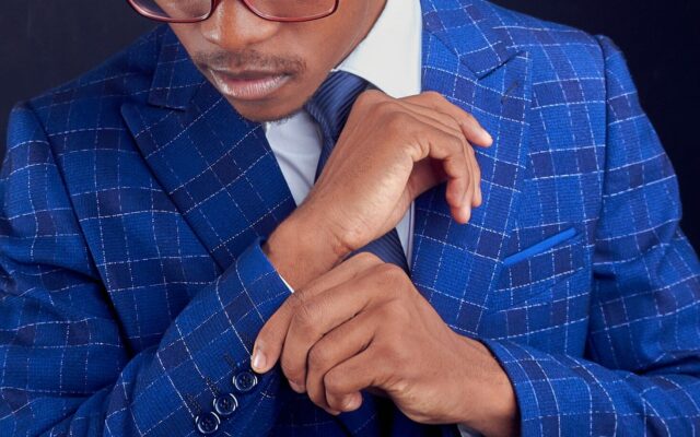 IP assignment tax in Kenya: African professional in a blue check suit, representing a buyer or seller of intellectual property