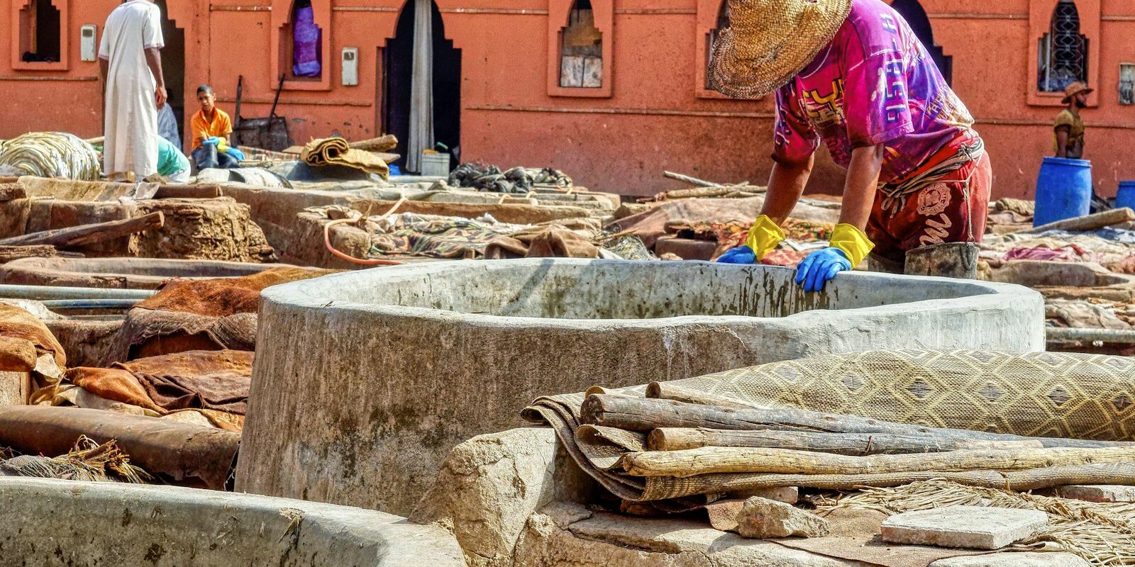 Worker processing hides at a traditional leather tannery in Morocco